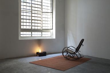 Juliette Blightman, This World is not my home, 2010, chair, rug, window, brazier, fire, dimensions variable. Courtesy of the artist and Galleria Zero, Milan
