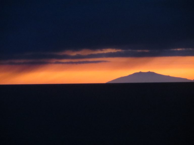 Sunset in Iceland mountain against orange sky