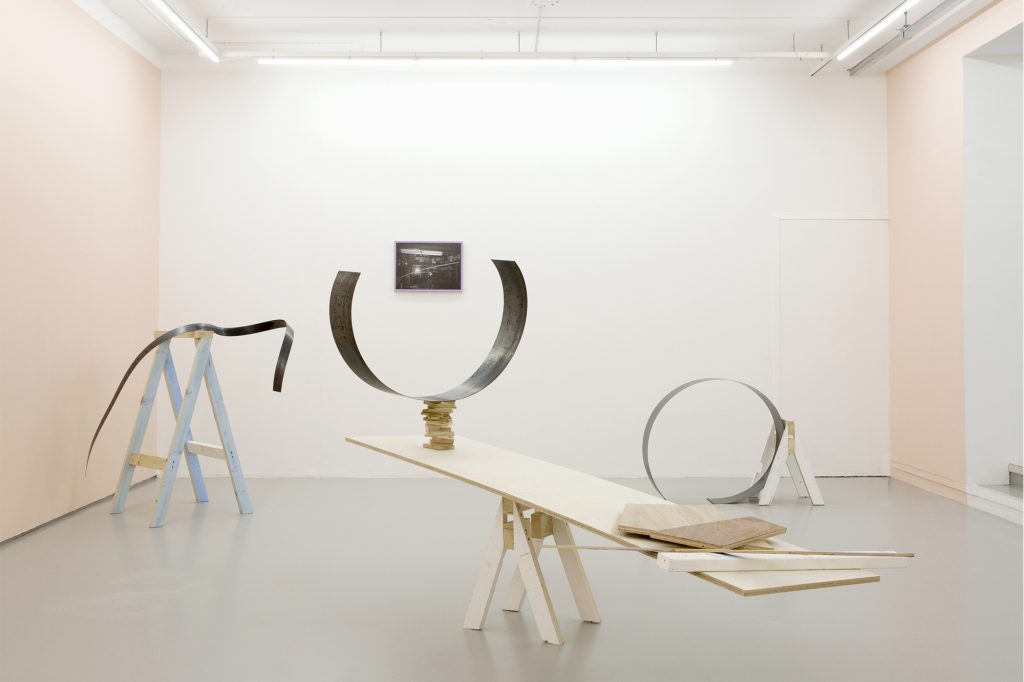 Installation view, Jan McCullough Tricks of the Trade, 2020, Photographic print, plywood, trestles, torqued steel, boiled linseed oil, frame emulsion: paint cloth lilac, wall emulsion: docket pink. Centre for Contemporary Art, Derry~Londonderry, Northern Ireland (28th November 2020 – 1st May 2021).