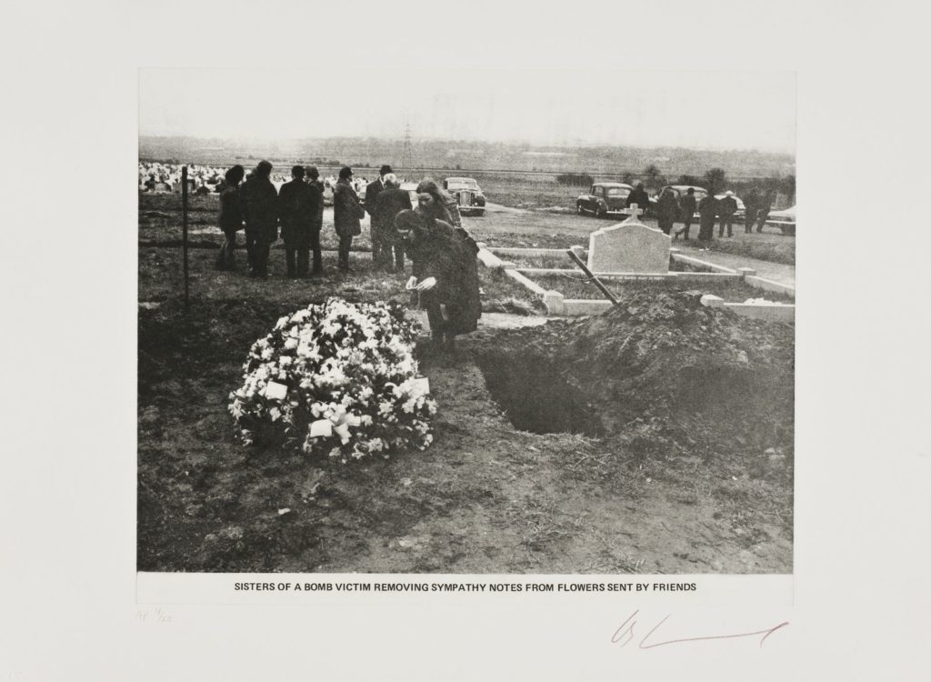 Artwork: Sisters of a bomb victim removing sympathy notes from flowers sent by friends