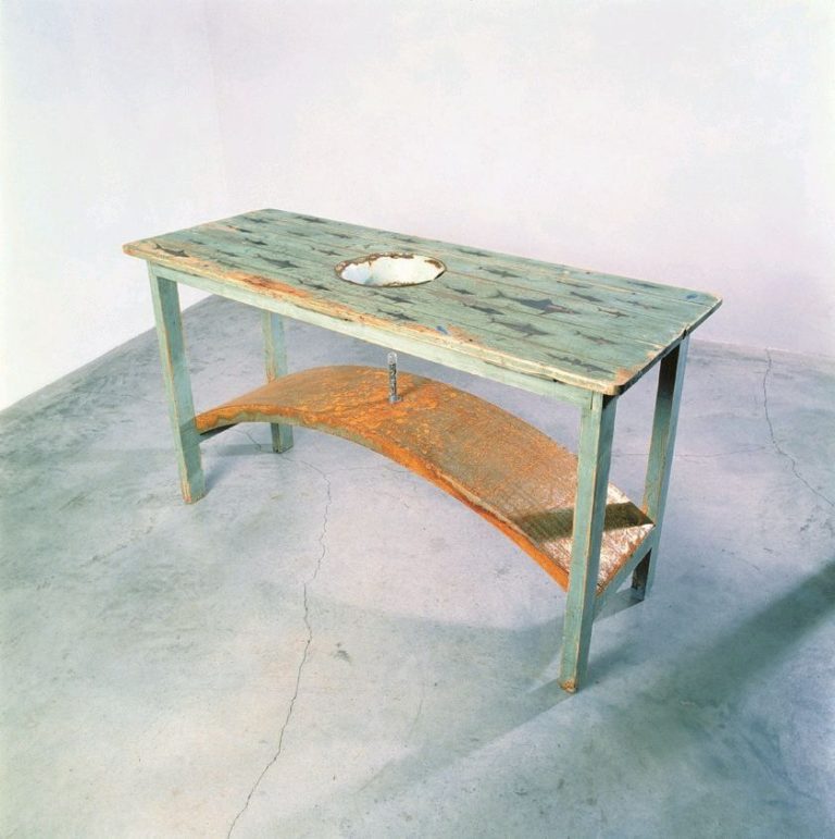 Gallery thumbnail. Dorothy Cross, Kitchen Table, 1990, Wood, enamel bowl, steel, glass test tube, fossilised sharks' teeth, Unframed, 90 x 162 x 60 cm, Collection Irish Museum of Modern Art, Purchase, 1991
